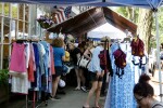 Flea market stand outdoors with clothing and other trinkets